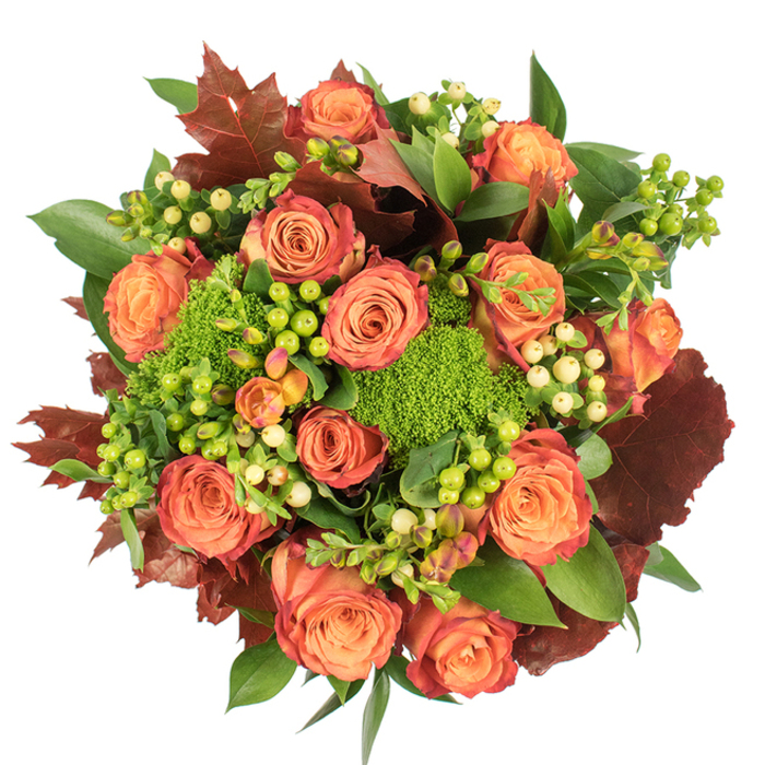 Viewed from a bird's-eye perspective on a stark white surface, this lush, circular bouquet brings together the comforting colours and textures of fall in a tightly composed study of contrast and harmony. The focal point is a congregation of large, fully bloomed roses whose petals graduate from soft, warm peach at their cores through coral and bright orange to outer edges kissed with reddish-rust, each bloom layered like a miniature autumn canopy. Interspersed among these classic roses are compact pom-poms of Green Trick dianthus - vibrant, velvety green clusters that read almost like living moss and give the arrangement architectural texture. Sprays of Hypericum berries provide small, glossy accents: some spheres glow lime green, others are pale cream or buttery yellow, creating delicate points of light against the deeper tones. A foundation of fresh green leaves, some broad and reflective, supports the composition while larger, lobed leaves in burgundy and burnt orange are placed as if fallen from a neighbourhood maple, lending weight and seasonal authenticity reminiscent of Headstone Manor gardens and the tree-lined streets around Hatch End station. The tactile contrast between velvety roses, smooth berries, and mossy dianthus is heightened by soft, overhead illumination that sculpts shadows and highlights. There's an implied scent of warm roses with an undernote of earthy green, evocative of an autumn market stall. Crafted with the steady hand of a local florist, this arrangement reads as both sophisticated and homey - perfect for Thanksgiving centrepieces, seasonal home styling, or as a thoughtful gift that captures the mellow comfort of Hatch End's autumn.